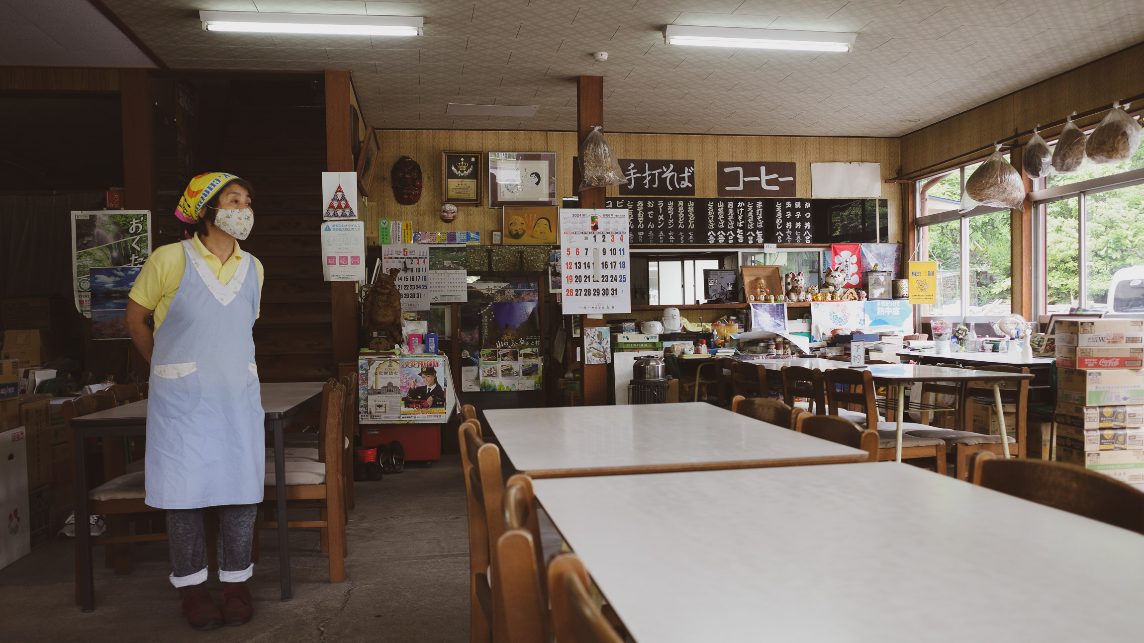 A waitress standing inside an Udon Shop by Lake Okutama, Japan
